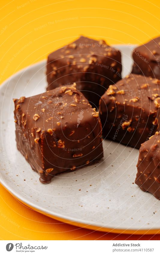 Cookies with chocolate and nut icing dessert cookie plate cube sweet food pastry tasty cuisine dish delicious yummy scrumptious sugar calorie portion piece