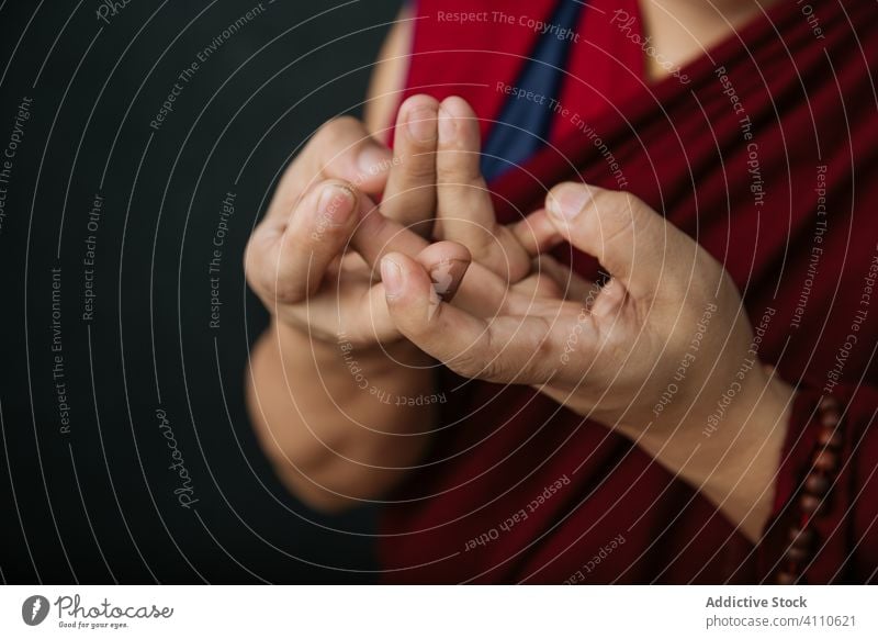 Buddhist monk with mudra hands gesture buddhist pray religion symbol traditional tibet red culture spirituality faith belief asia authentic holy sacred mantra