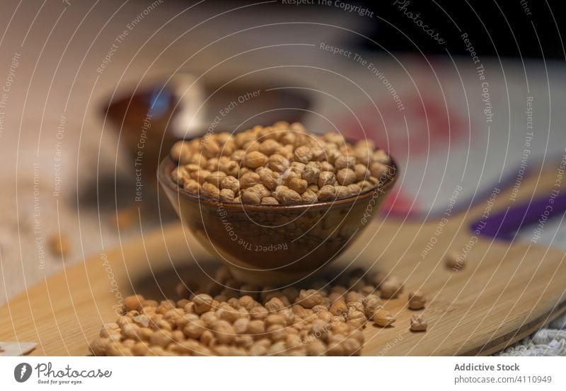 Heap of chickpea on wooden board heap kitchen cutting board raw natural food organic ingredient pile fresh healthy nutrition vegetarian vegan bunch edible diet