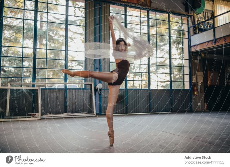 Young woman in bodysuit dancing with veil in studio dance grace light rehearsal romantic ballerina elegant flexible slim choreography alone motion tulle young