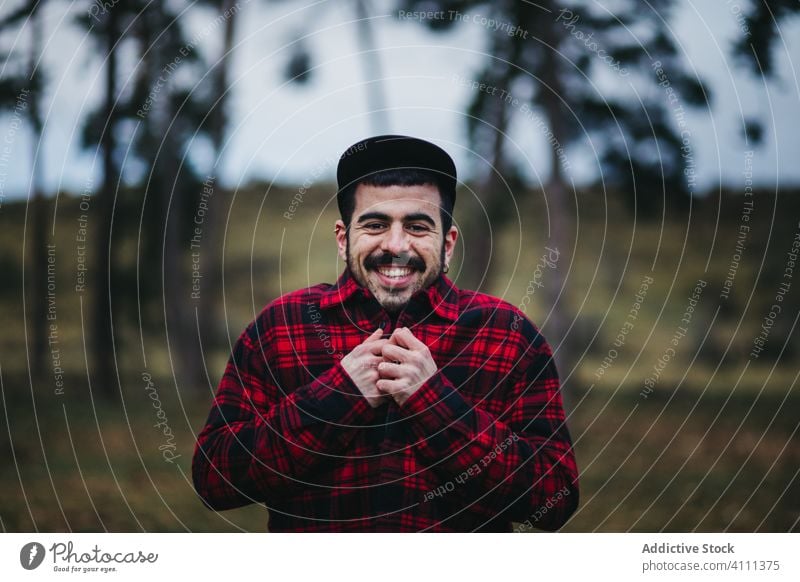 Man in peaceful green forest man tree nature trunk countryside environment travel lifestyle tourism activity beautiful woods freedom tranquil wild season