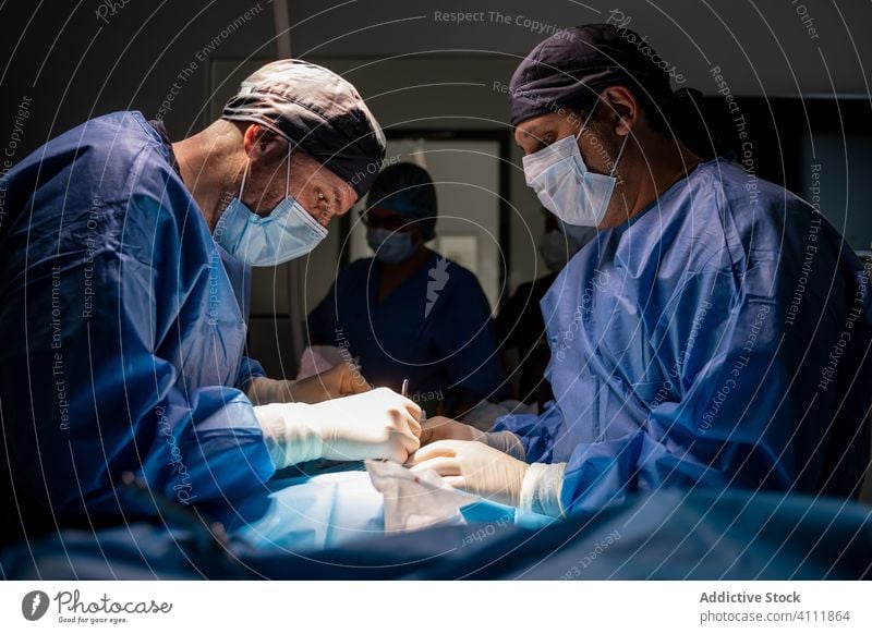 Medical staff during surgery in modern clinic surgeon hospital medic medicine doctor treatment surgical nurse work medical practitioner people specialist