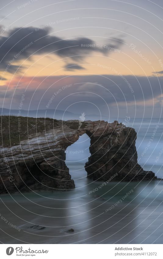 Lonely rocky coast of ocean in sunset nature water sky cliff stone landscape picturesque tourism shore travel sea beautiful tranquil cloud idyllic evening wave