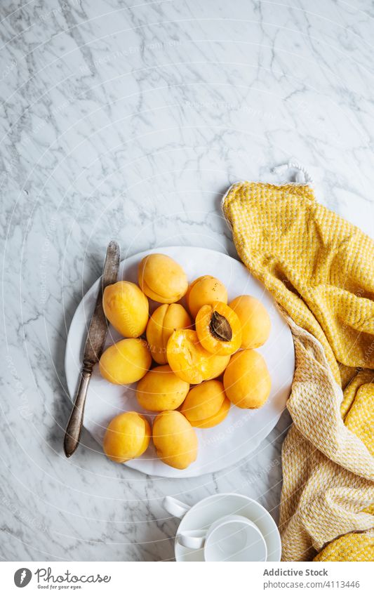 Plate with fresh apricots on white marble table fruit ripe plate yellow orange natural food delicious tasty healthy organic ingredient nutrition meal cuisine