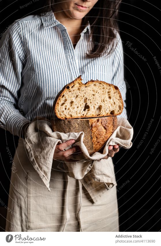 Baker showing cut bread loaf food fresh half artisan homemade delicious baker woman crust tasty meal nutrition natural healthy cuisine female sourdough