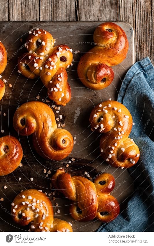 Appetizing sweet buns on wooden table food bake homemade tasty pastry curl yummy fresh saffron tradition nutrition appetizing eat cook culinary gastronomy