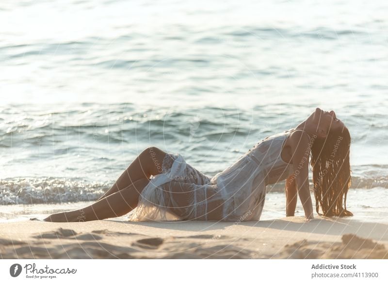 Happy woman lying near waving sea wave wet smile dress joy resort water female eyes closed relax clean rest pleasure harmony tranquil splash happy idyllic