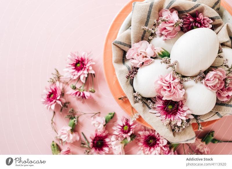 Flower and eggs composition near plate flower easter spring season decor tradition holiday celebrate blossom bloom design arrangement petal festive event