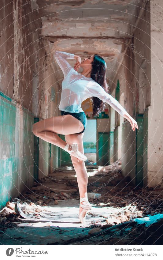 Young ballerina dancing in grungy corridor woman dance ballet grace concept grunge abandoned young slim female elegant looking up demolish perform dancer