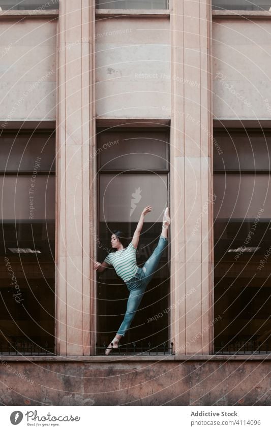 Ballerina stretching outside shabby building woman dance ballet grace concept split young female slim elegant ballerina perform dancer move flexible motion