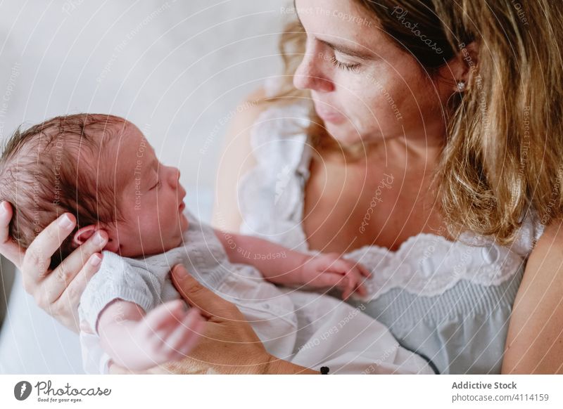 Happy mother holding newborn child happy woman baby care together love motherhood smile kid parent adorable childhood innocent infant little cute comfort