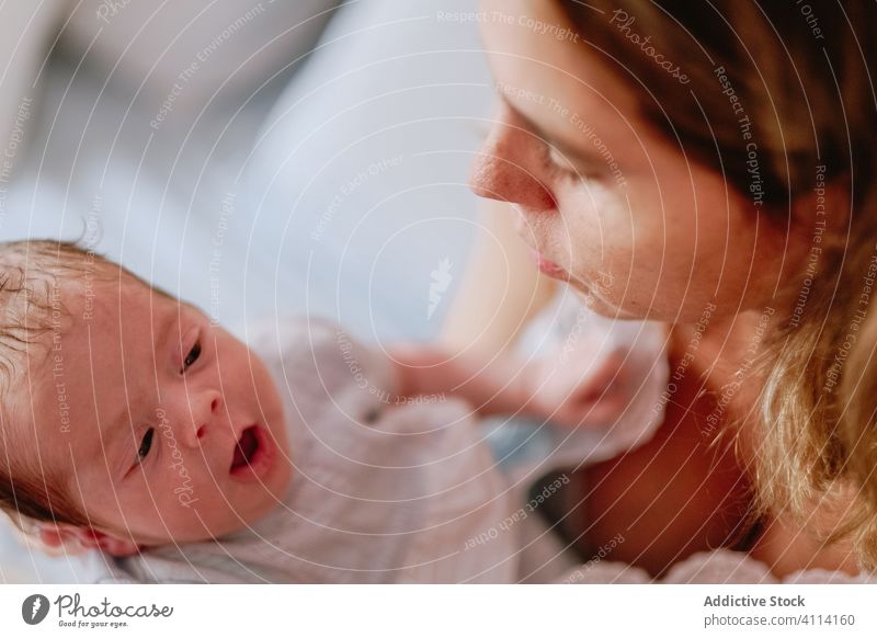 Happy mother holding newborn child happy woman baby care together love motherhood smile kid parent adorable childhood innocent infant little cute comfort