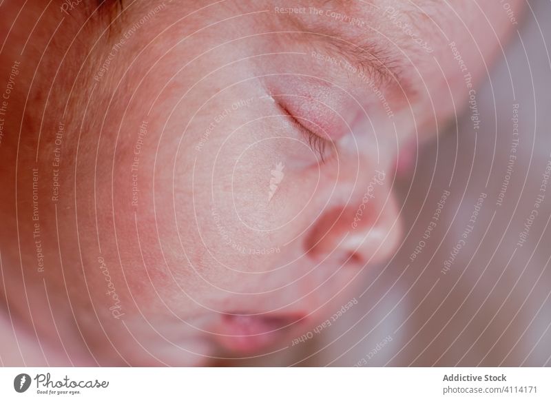 Calm face of small relaxed infant sleeping in soft bed at home newborn baby mouth tranquil kid lip calm nose innocent rest little harmony cute silent peaceful