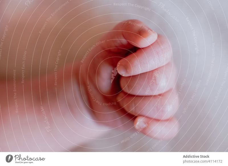 Small cute hand of little relaxed baby sleeping in bed at home infant kid child calm palm nail finger innocent newborn tranquil small harmony peaceful bed time