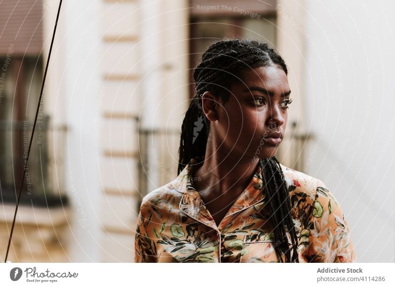 Young woman with cup of coffee standing on balcony calm drink casual home tranquil thoughtful relax young african american black ethnic brunette house city