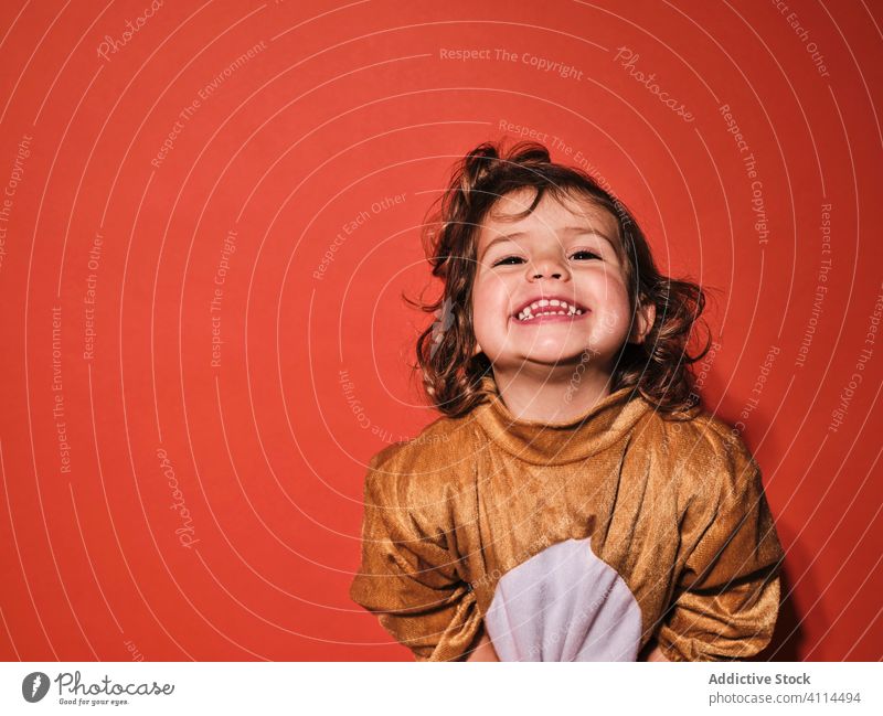 Cheerful little girl in cute animal costume kid happy charming laugh joy cheerful adorable child female infant innocent childhood expressive positive fun smile