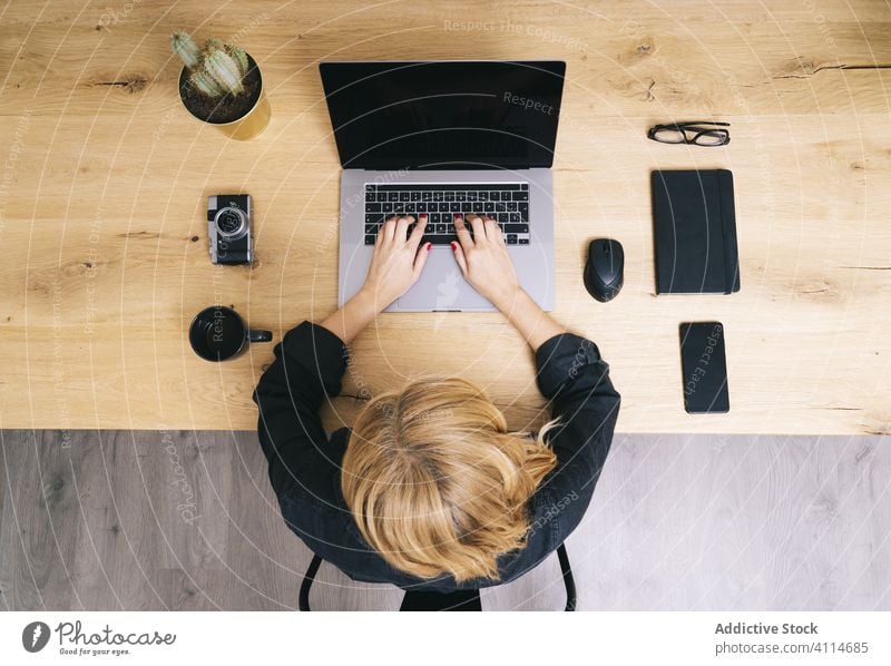 Woman working from her studio office at home. computer technology business desk workplace woman coffee laptop view internet using education cup phone wooden mug