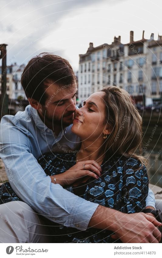 Affectionate couple resting on street embrace happy love enjoy city historic together relationship travel romantic boyfriend girlfriend hug date affection