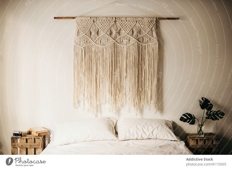 Interior of cozy retro bedroom interior vintage comfort macrame wall decoration hang home nobody warm ornament thread rope morning romantic linen fabric