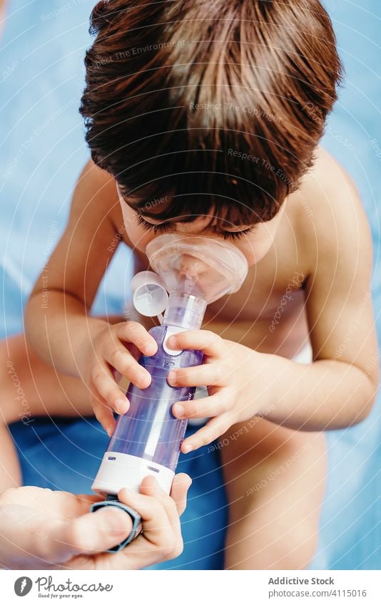 Sick boy getting inhalation treatment in clinic child inhale respiration sick medicine medical respiratory doctor mask little woman hospital health care patient