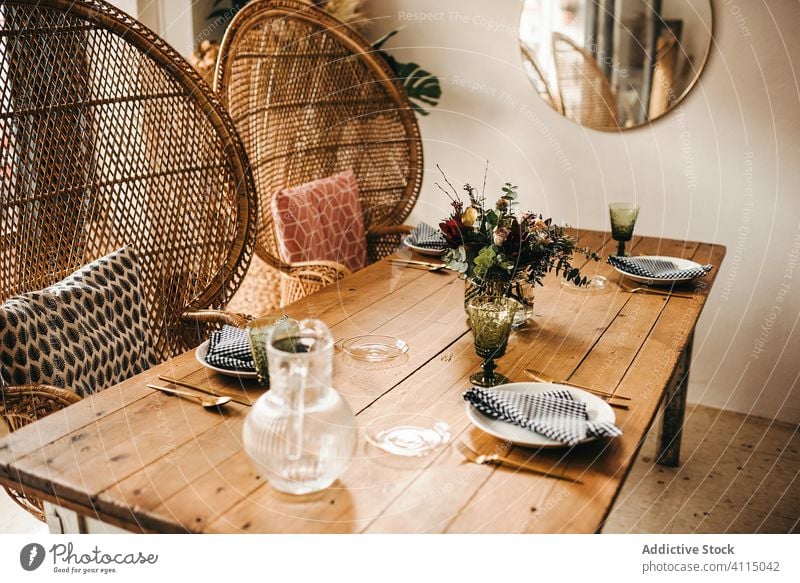 Flowers and plant twigs on a vase decorating a wooden table flowers bunch leaf bouquet water petal concept glass fresh bloom interior vintage nature decorative