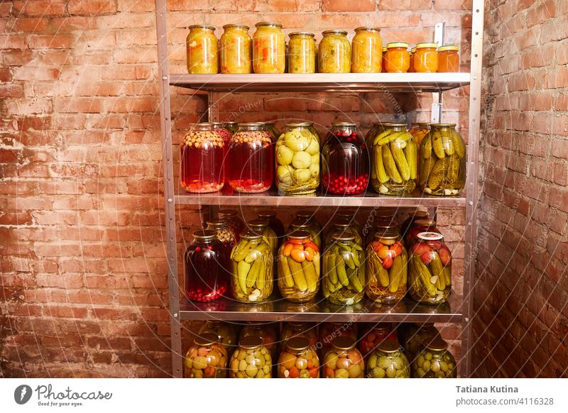 storage of vegetables and fruits for the winter. Shelving with banks with blanks in the home cellar. background canning food glass nature reserve basement