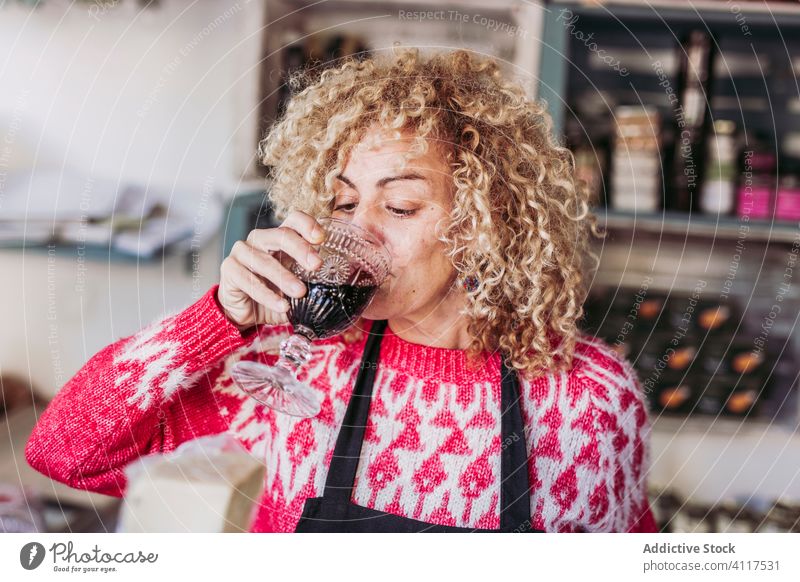 Bartender tasting wine in glass bartender shop tap local seller beverage drink alcohol retail tradition small business owner authentic pub store service cup