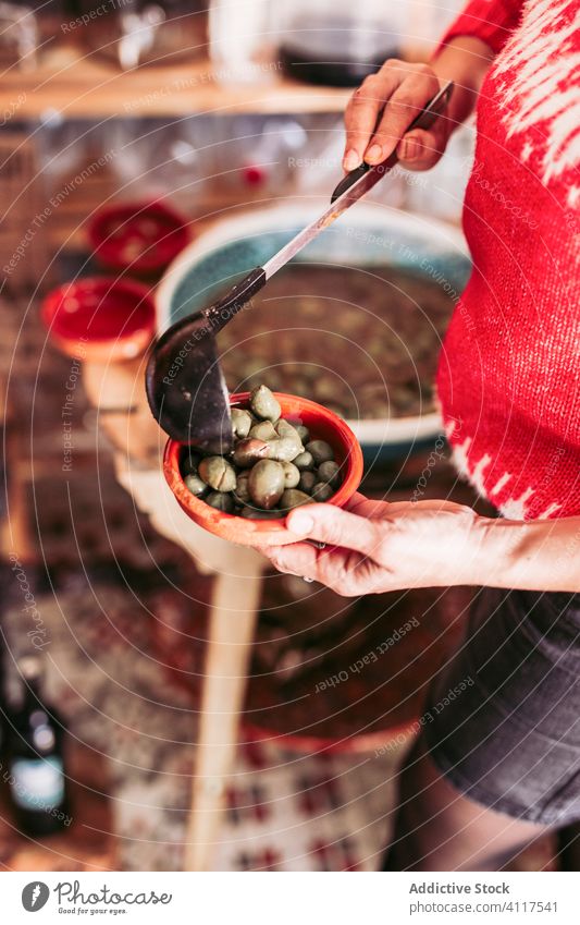 Crop seller putting olives in bowl shop service ladle food local work gourmet organic occupation store small business owner vendor ingredient portion snack