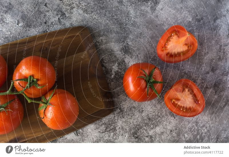 Ripe tomatoes on gray table kitchen fresh cook ingredient half whole food organic healthy vegetable cuisine ripe natural vegetarian nutrition diet recipe