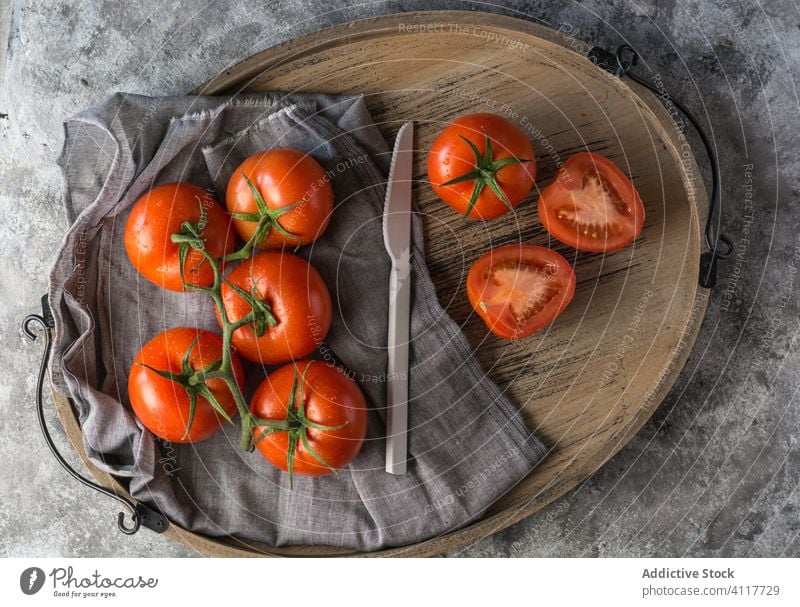 Ripe tomatoes on gray table kitchen fresh cook ingredient half whole food organic healthy vegetable cuisine ripe natural vegetarian nutrition diet recipe