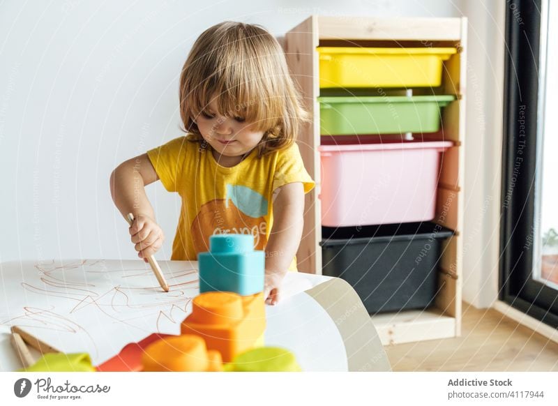 Focused little kid drawing at table education pencil creative preschool colorful cute girl learn childhood adorable play casual activity kindergarten