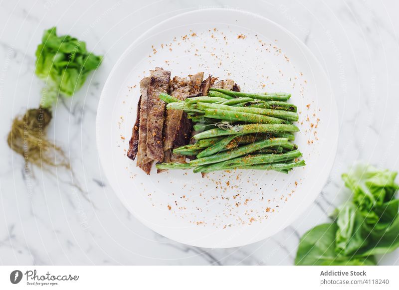 Steak and green beans on plate salad steak spice meat vegetable healthy food dinner bunch seasoning arrangement greenery portion gourmet natural diet slice