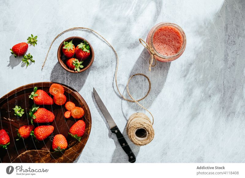 Healthy strawberry drink in glass jar juice homemade rustic fresh natural healthy twine knife tasty ripe delicious food vitamin ingredient nutrition appetizing