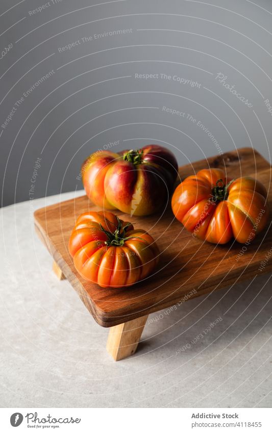 Composition with red tomatoes on table fresh ripe natural raw wooden board food vegetable cook whole appetizing kitchen healthy meal vegetarian eat diet harvest