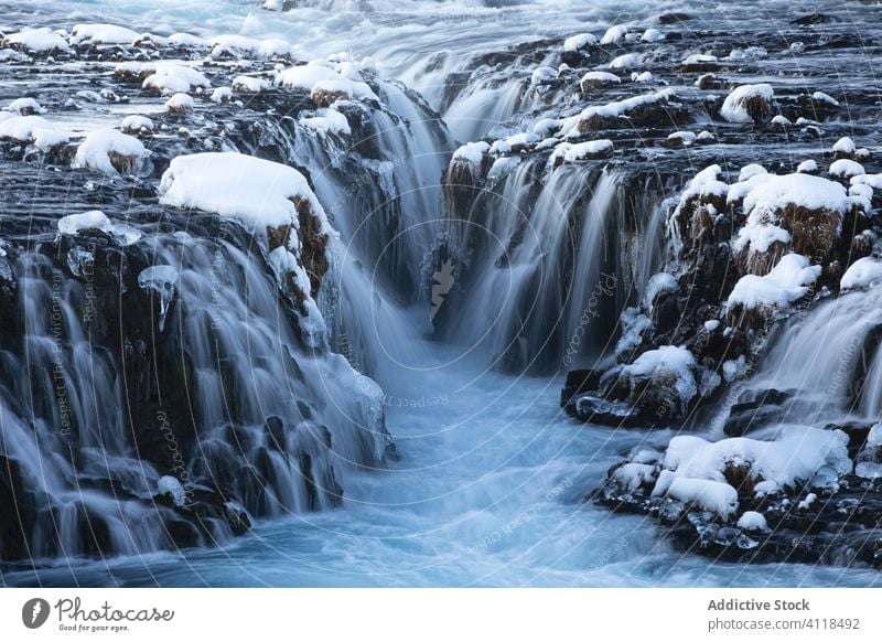 Frozen waterfalls on rocky terrain river frozen rough north nordic snow severe iceland volcanic scenery arctic winter landscape cascade nature stone travel