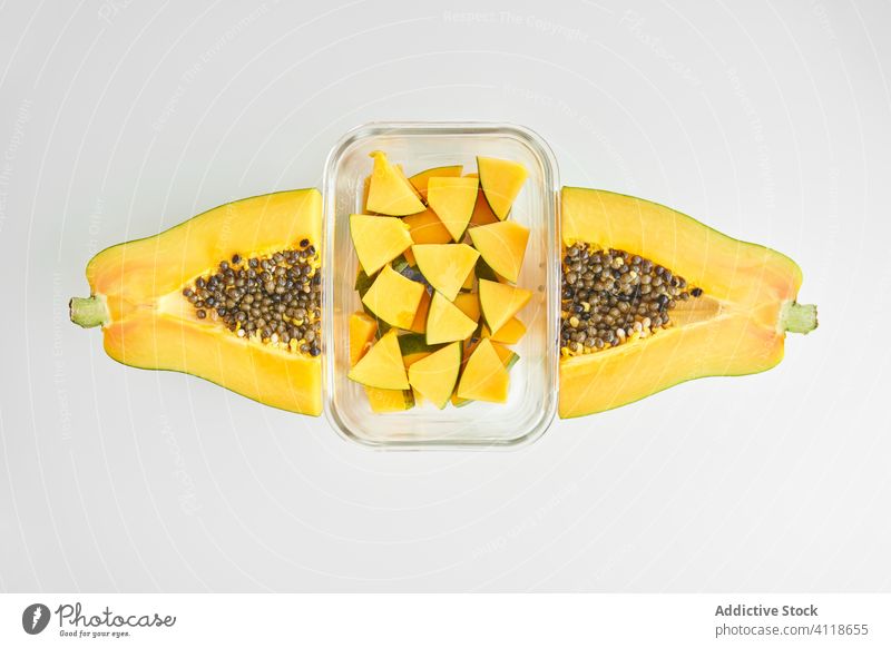 Glass container and cut papaya tropical piece ripe seed fresh food half fruit dessert healthy summer serve sweet snack vegetarian slice vegan diet exotic