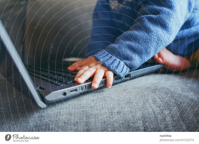 Close up of a baby using a laptop close up technology port usb hdmi keyboard hands touch touching pc computer home living room life lifestyle future progress