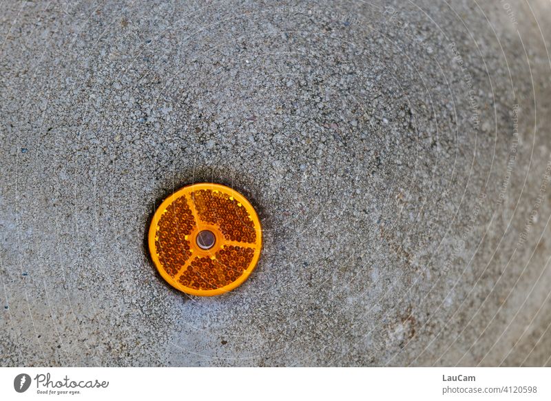 Orange reflector on a grey concrete bollard Reflector Reflection signal colour Safety Bollard Concrete Boundary limiting pillar esteem Attention!