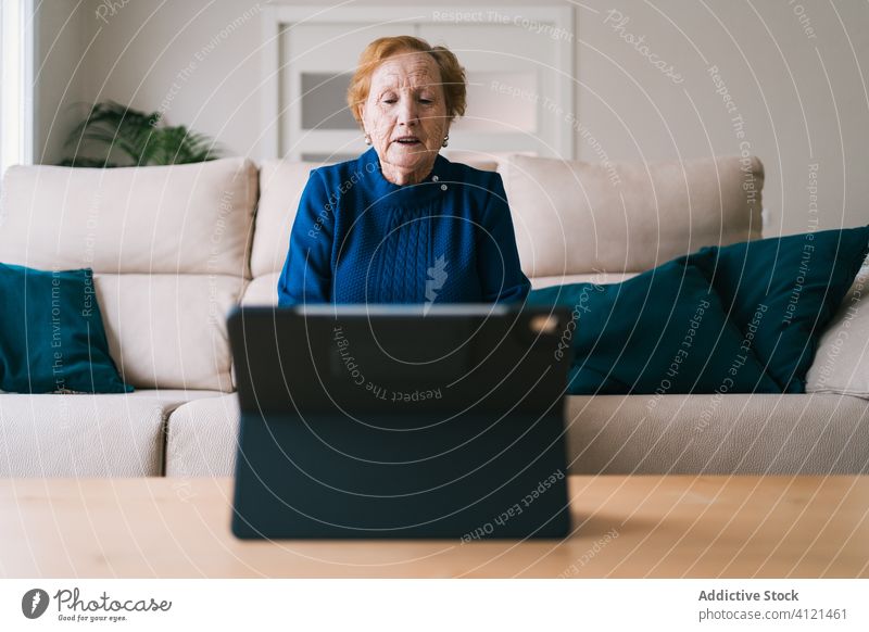 Old woman communicating with daughter on video chat on laptop video call home senior meeting using online remote distance coronavirus isolation quarantine