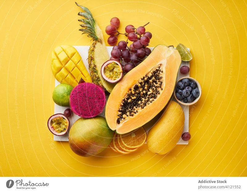 Top view of flat lay with tropical fruits on a tray exotic papaya hawaii ingredients natural organic food pitaya dragon passion green colorful juicy sweet ripe