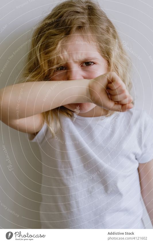 Little girl crying in studio weep naughty little child whine casual sad frown disappoint kid childhood face expression adorable cute t shirt blonde apparel