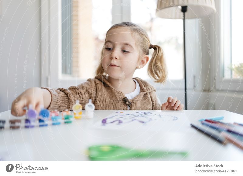 Little girl using gouache for drawing with fingers on paper at home child paint kindergarten creative kid cute education pencil learn elementary little adorable