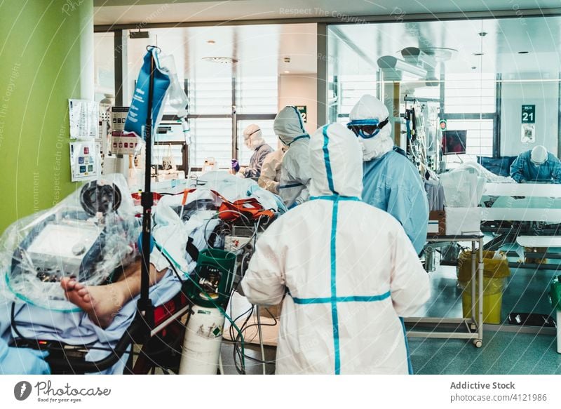 Doctors in protective uniform working in operating room in hospital doctor clinic viral patient care infection equipment treat specialist mask health care