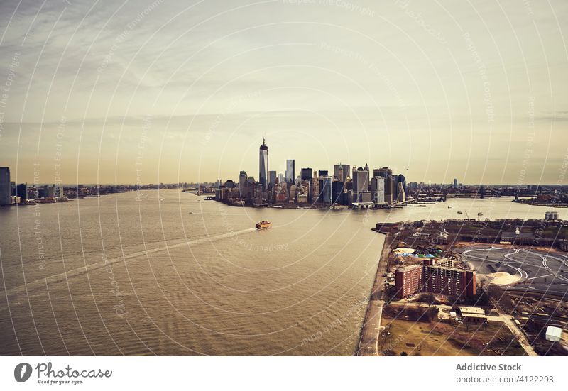 City skyscrapers and island in sunset light city channel cityscape aerial new york bay manhattan america infrastructure usa united states architecture tower