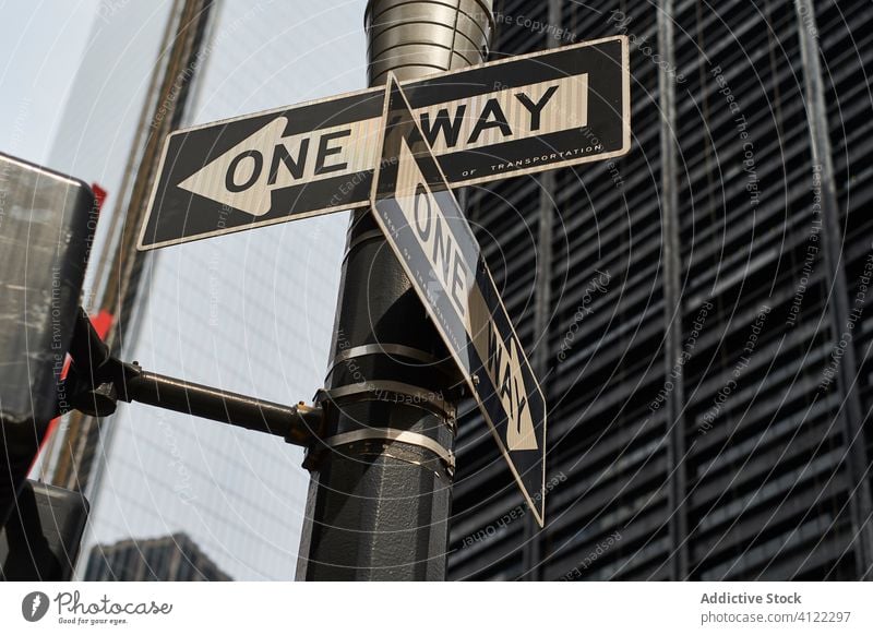 Road sign in modern city road traffic arrow way crossroad signpost street crosswalk building new york usa america skyscraper architecture manhattan urban