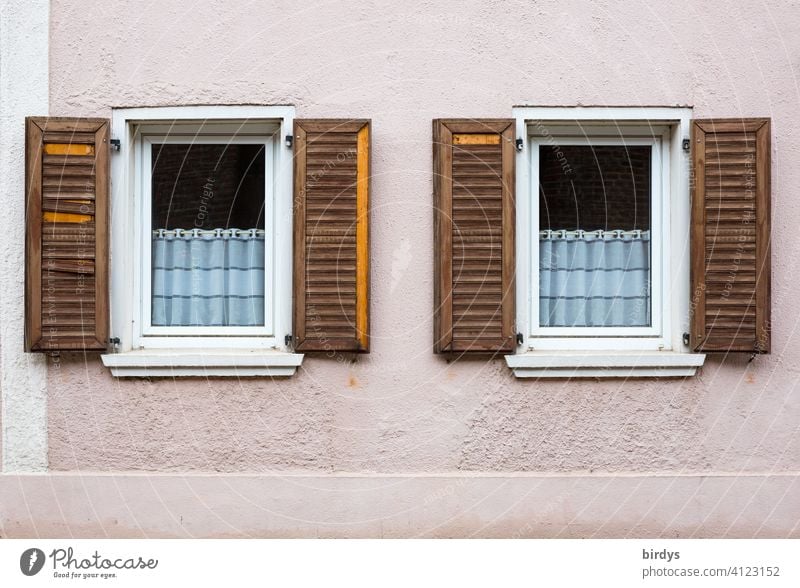 Facade with 2 windows and broken wooden shutters. Abandoned house in Keyenberg / NRW, the village is to be destroyed by RWE to get climate-damaging brown coal.