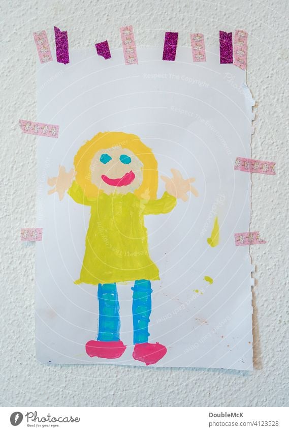 A child's picture pasted on the wall, depicting a cheerful girl, painted with watercolours Wall (building) childhood photograph Children's drawing Drawing Girl