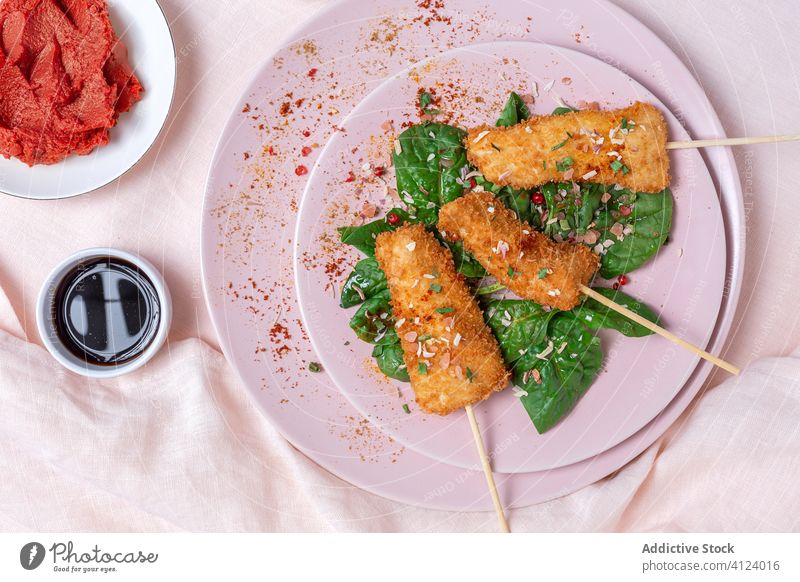 Battered chicken skewers in fried panko on restaurant table breaded food crispy snack meal golden appetizer dinner crunchy gourmet coated delicious cooked hot