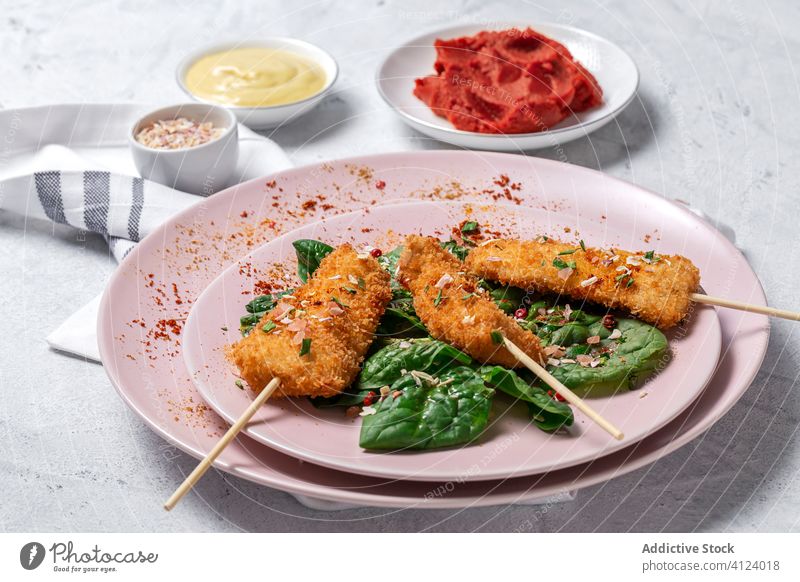 Battered chicken skewers in fried panko on restaurant table breaded food crispy snack meal golden appetizer dinner crunchy gourmet coated delicious cooked hot