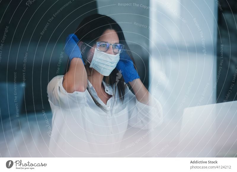 Woman in protective mask and gloves working at home woman coronavirus covid safety pandemic risk window disease female serious outbreak put on infection prevent